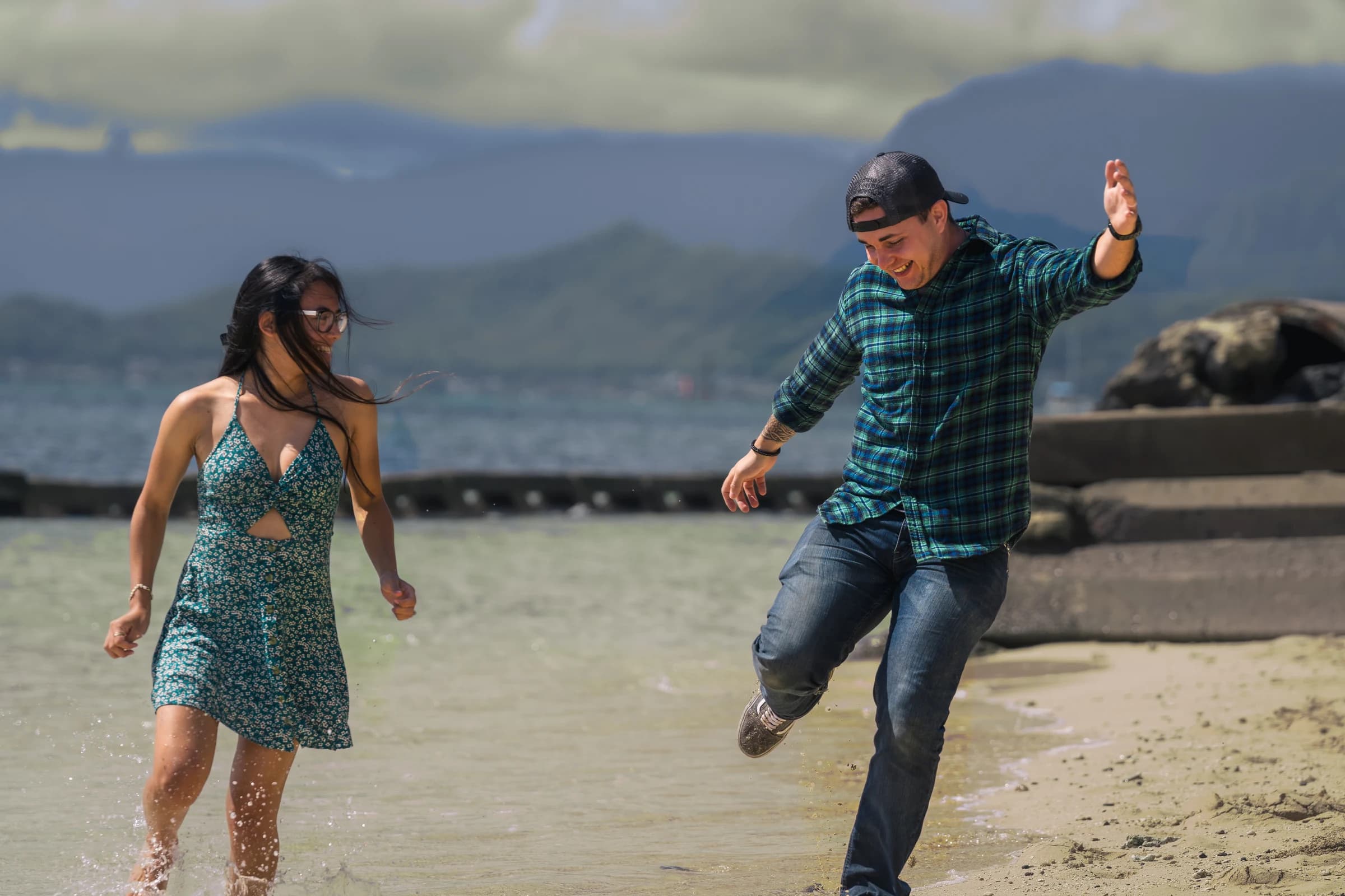Couple moving through the water at a windward Oʻahu beach
