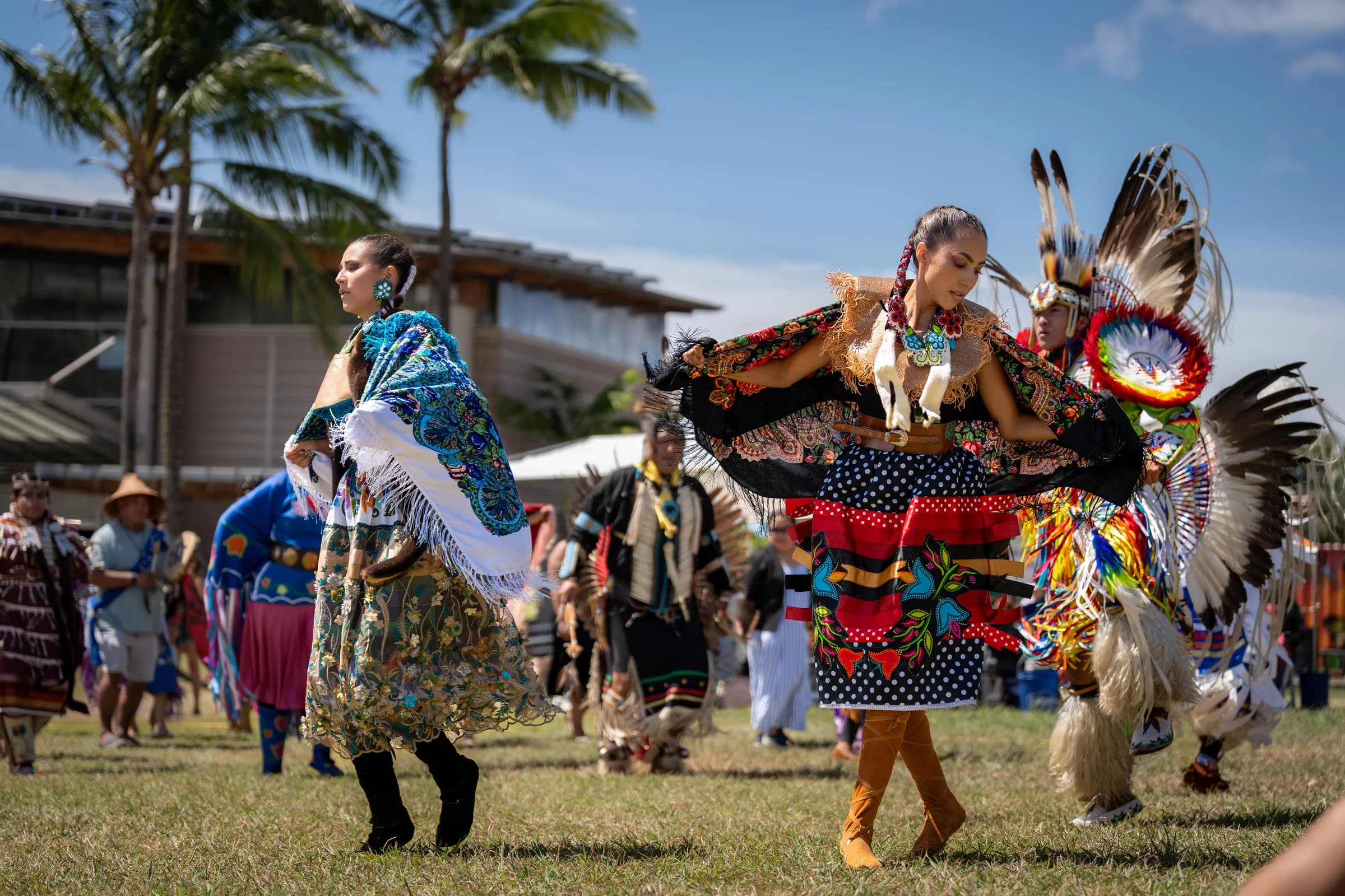 Dancers in traditional regalia at a community gathering