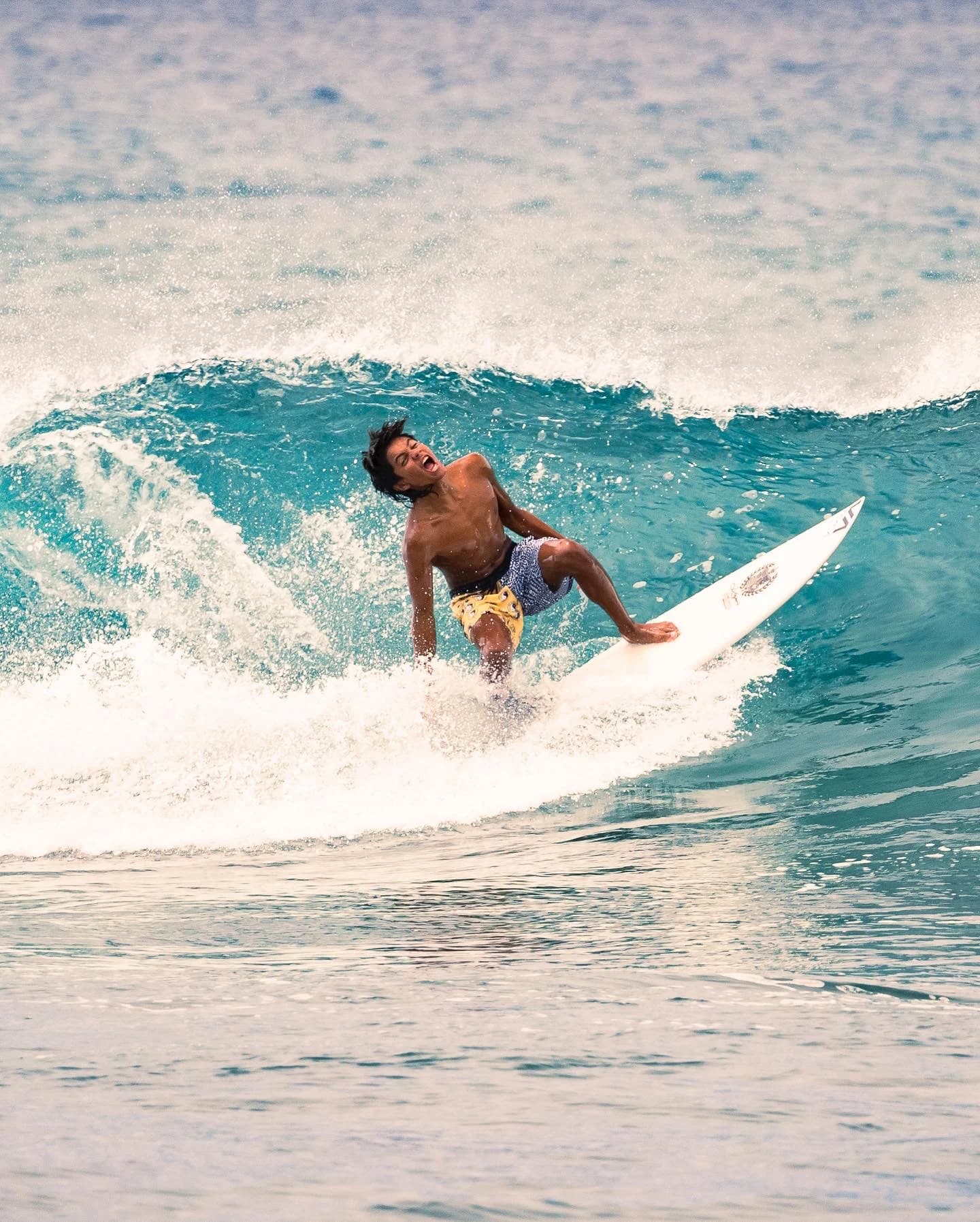 Surfer carving through a turquoise wave