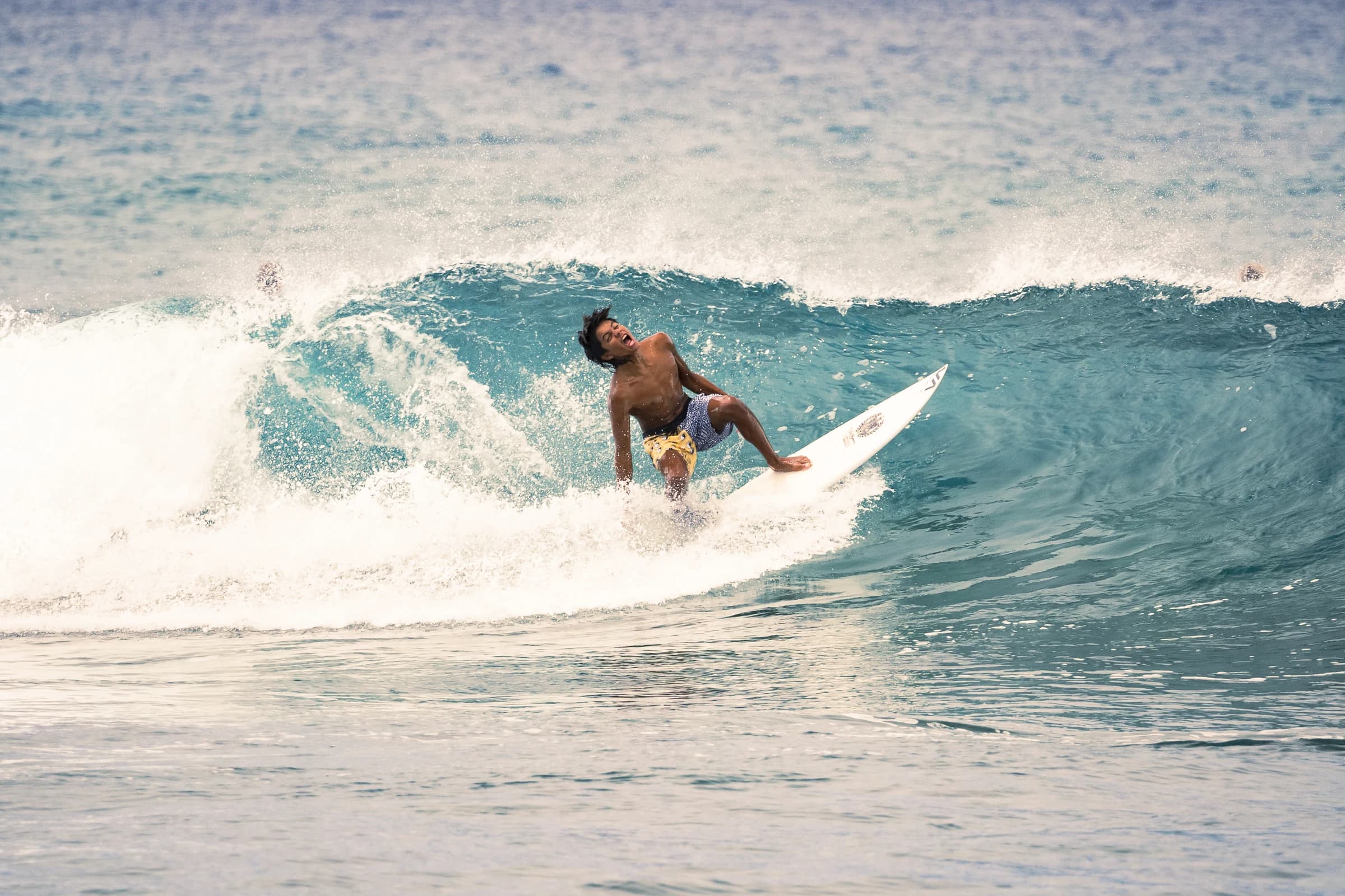 Surfer riding down the face of a wave
