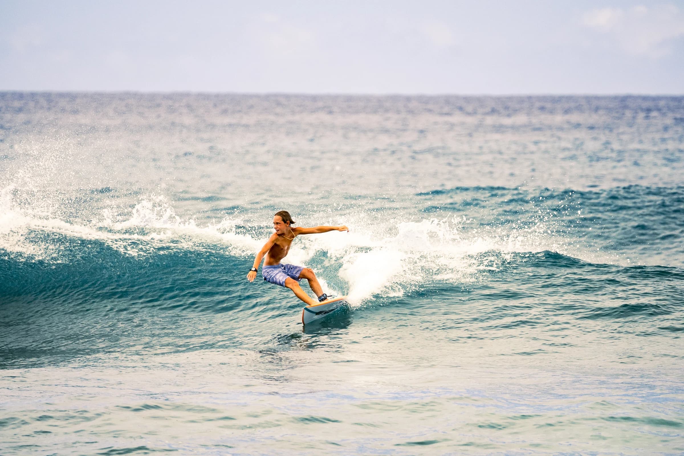 Surfer framed by a breaking wave
