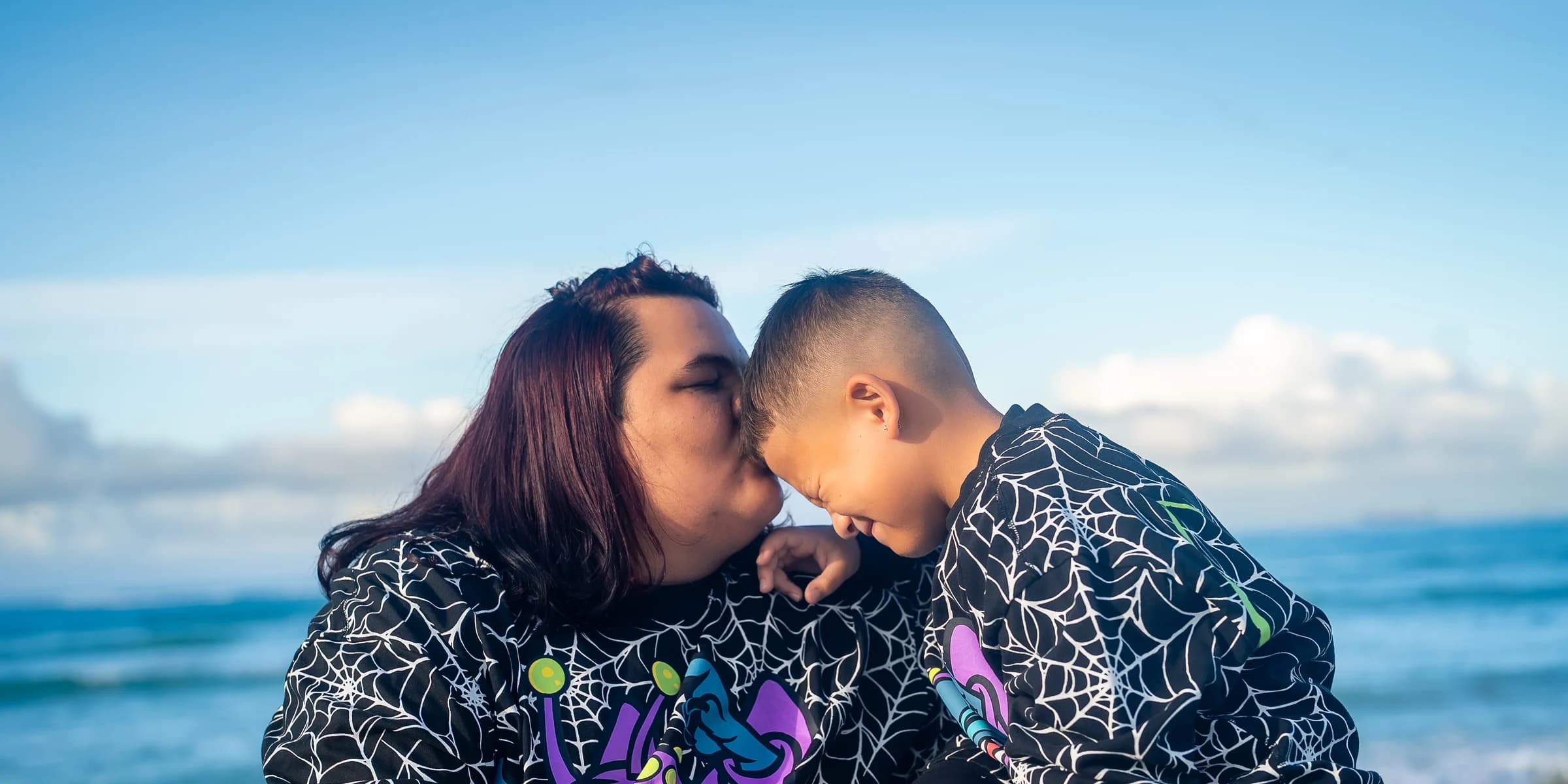 Parent and child photographed together at the shore