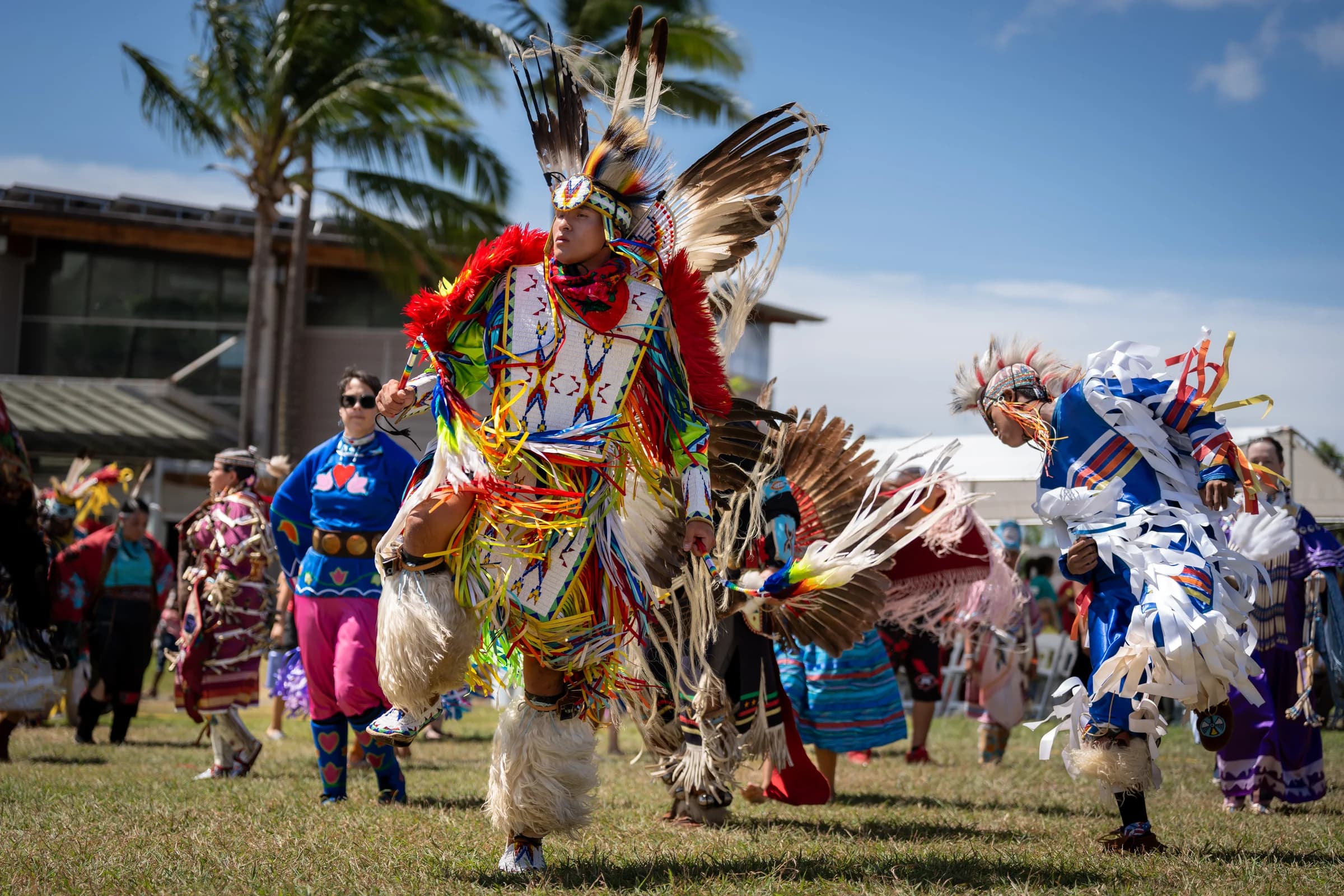 Intertribal powwow dancers moving through the arena in colorful regalia